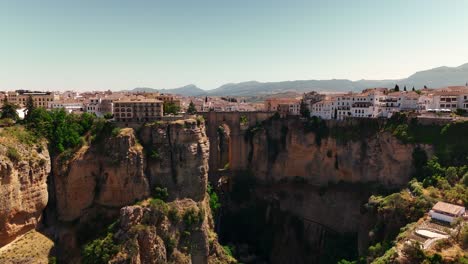 el tajo de ronda bridge on a bright sunny day with the whole city in the background (drone footage)