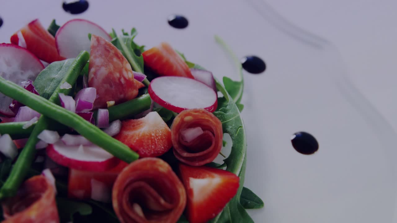 Camera sliding right after track, light bars shifting across salad, revealing plate rim for menu