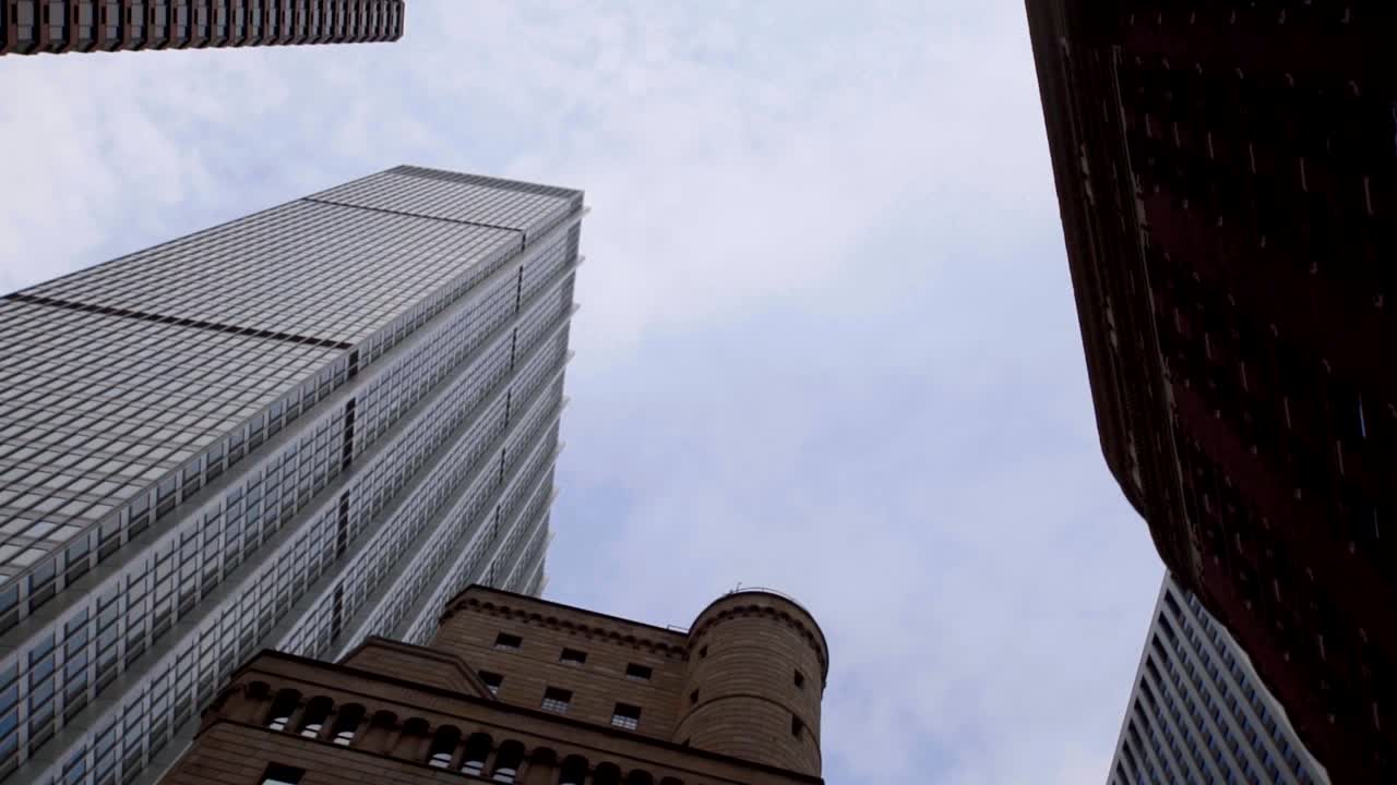Upward rotating view of NYC buildings from Third Avenue street level. Rotating The Camera With A View From Above On Skyscrapers