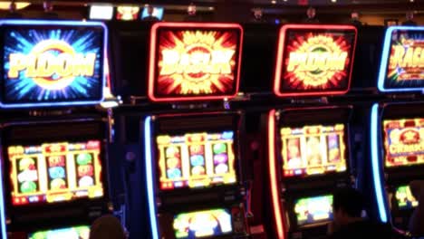 illuminated slot machines displaying vibrant symbols and engaging graphics in a casino setting, capturing the excitement of gaming