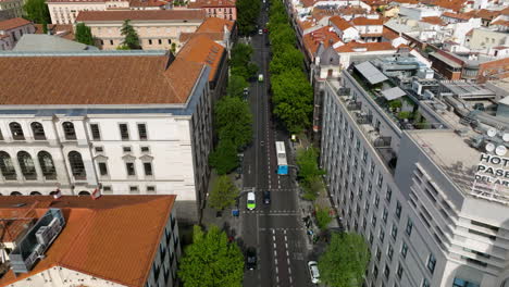 flying over asphalt road through medieval cityscape of madrid, spain