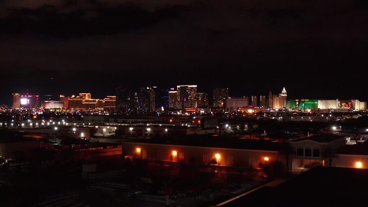 Wide rising aerial shot of the south and central Las Vegas Strip at night