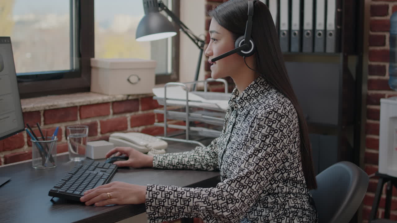 Call center operator talking to clients on phone call with microphone