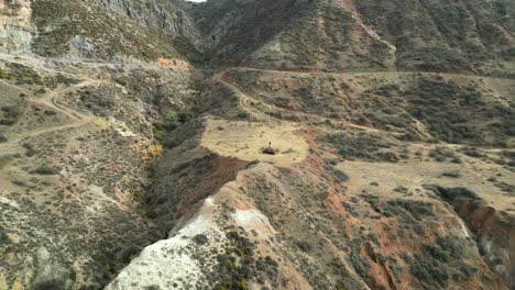 Soaring-high-above-a-rugged-cliff,-capturing-a-breathtaking-top-down-perspective-of-the-serene-Mediterranean-Sea