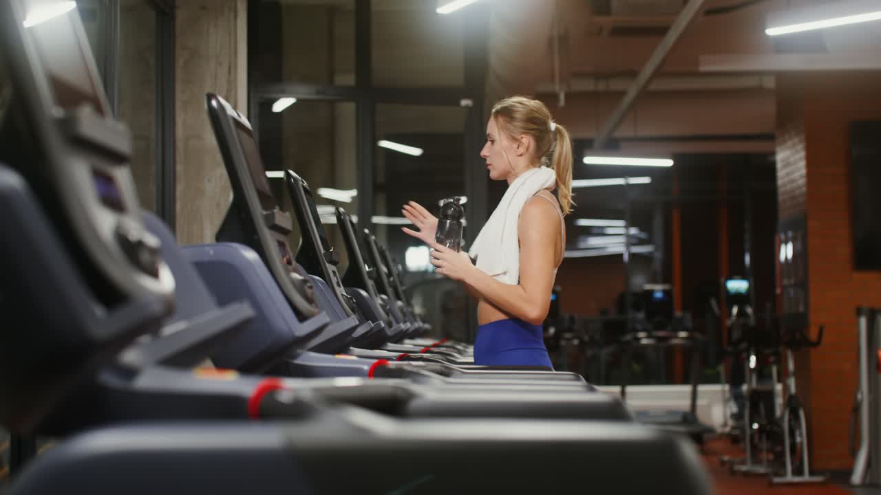 Woman Exercising on Treadmill in Gym