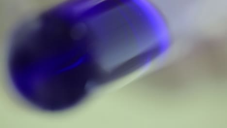 lab experiment with blue liquid in vial