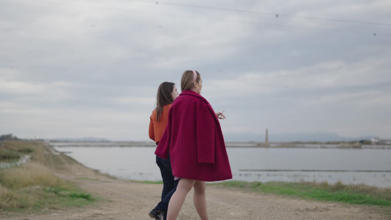 Friends Exploring a Lakeside Path