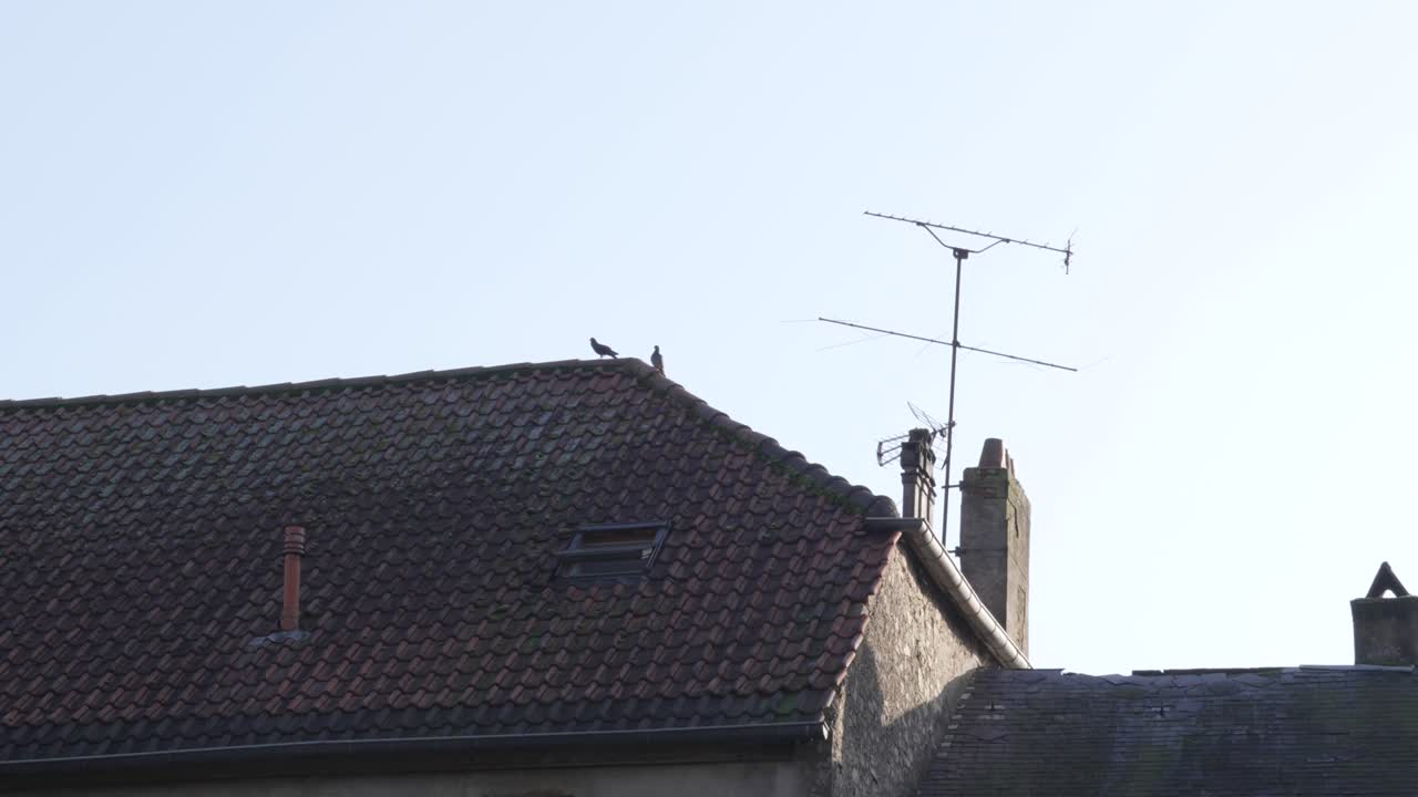 Close-up view of a tiled residential roof architectural feature European home in winter