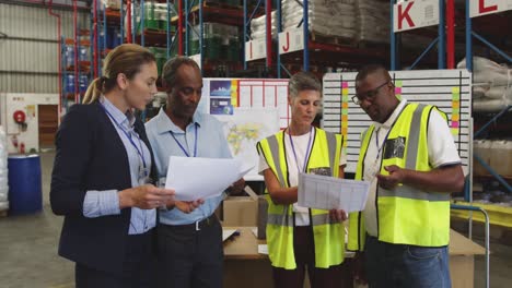 warehouse staff with documents talking 4k