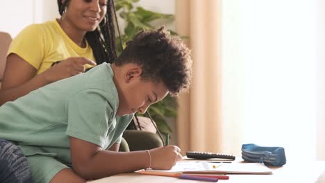 child and adult drawing together at home