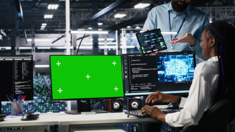 female programmer talking with manager in ai data center, using mockup pc