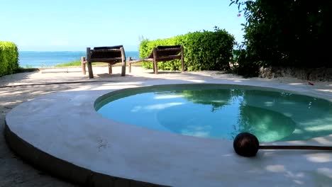 panning right shot of a terrace with a private circular pool with indian ocean views in luxurious resort