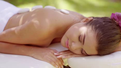 Pretty-young-woman-enjoying-a-hot-stone-massage