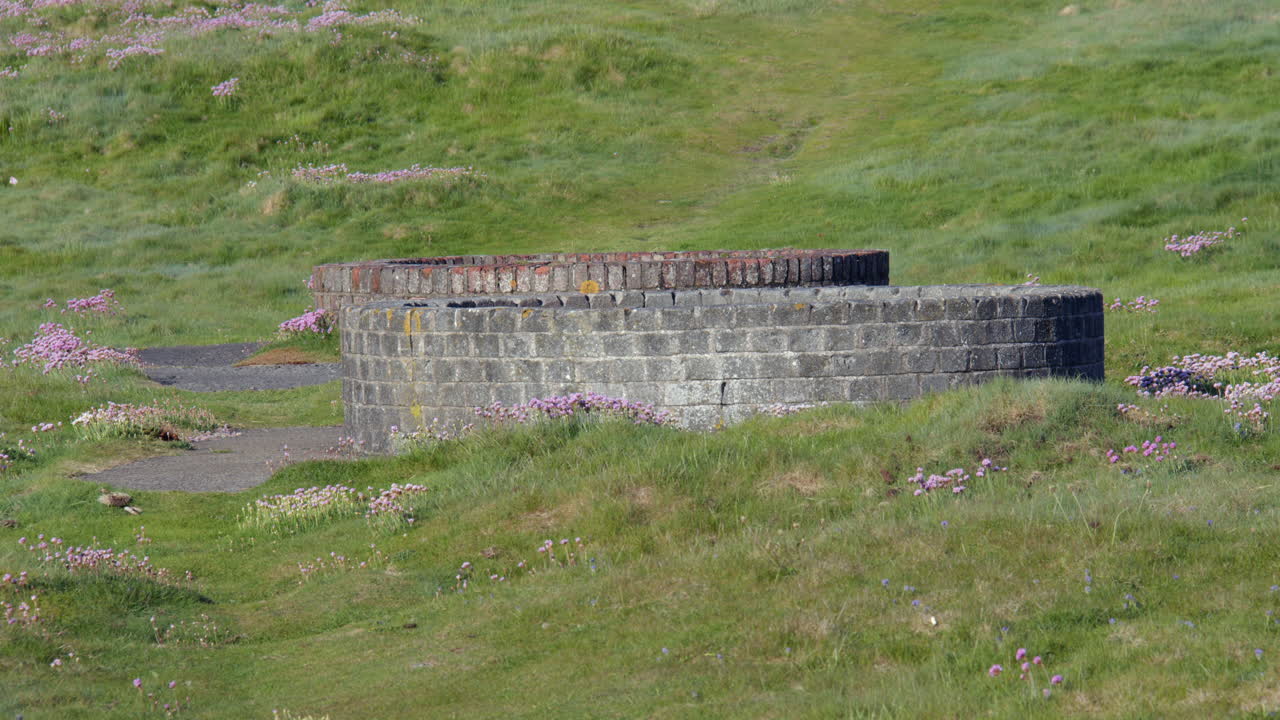 mid shot of Derelict military infrastructure at the headland at Hafan y Môr on Pen-y-chain, Pwllheli