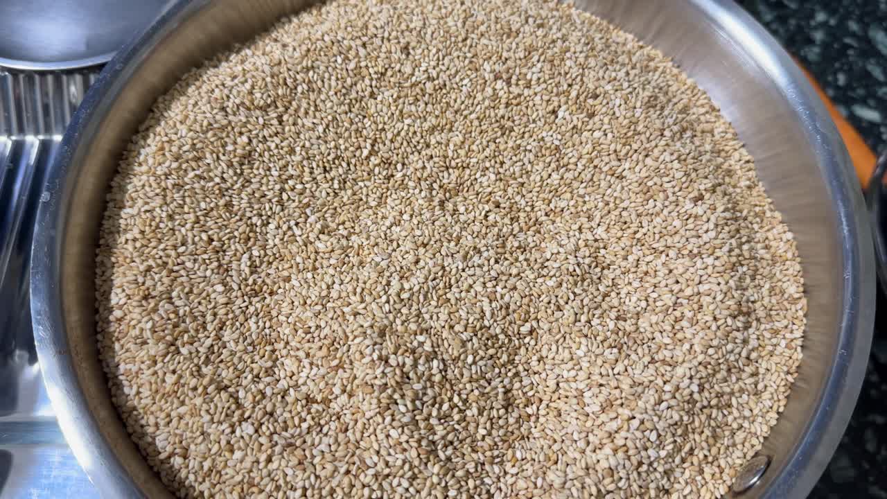 rosted sesame seeds on the plate to make sesame laddu for Makar Sankranti festival