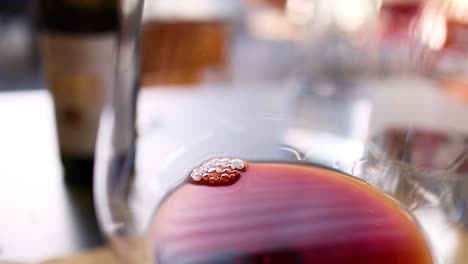 close-up of wine being poured into glass