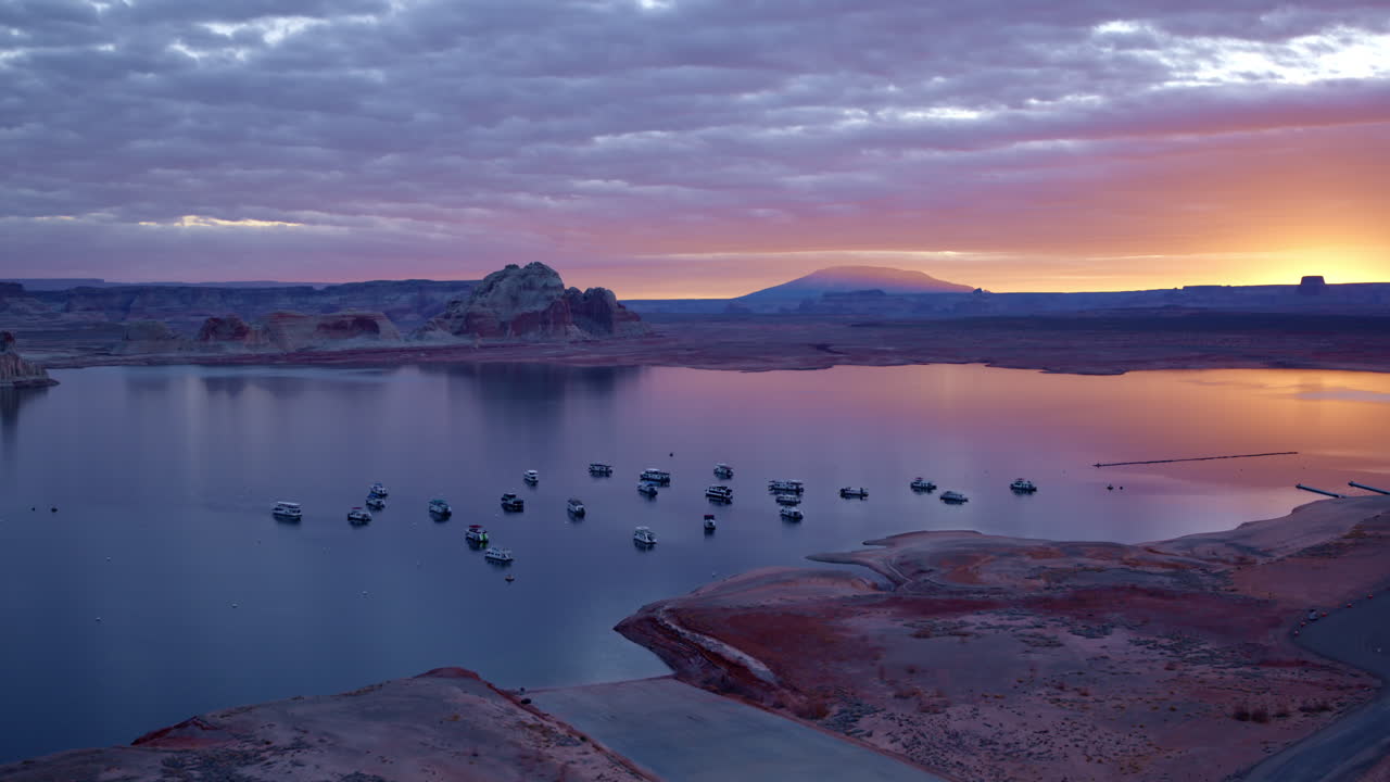 drone shot flying over boats at dawn on lake powell near Page Arizona