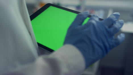 Nurse-holding-mockup-digital-tablet-closeup.-Doctor-touching-green-screen-laptop