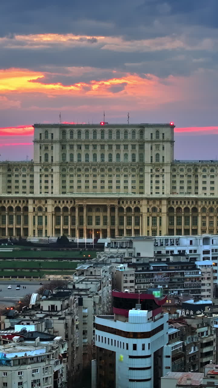Vertical aerial drone view of Palace of the Parliament in Bucharest downtown at sunset. Romania