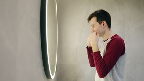 man looking at himself in a mirror, looking stressed