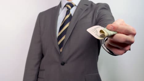 businessman shows a fifty dollar bill