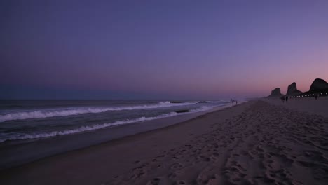 escena de la playa al atardecer con la gente