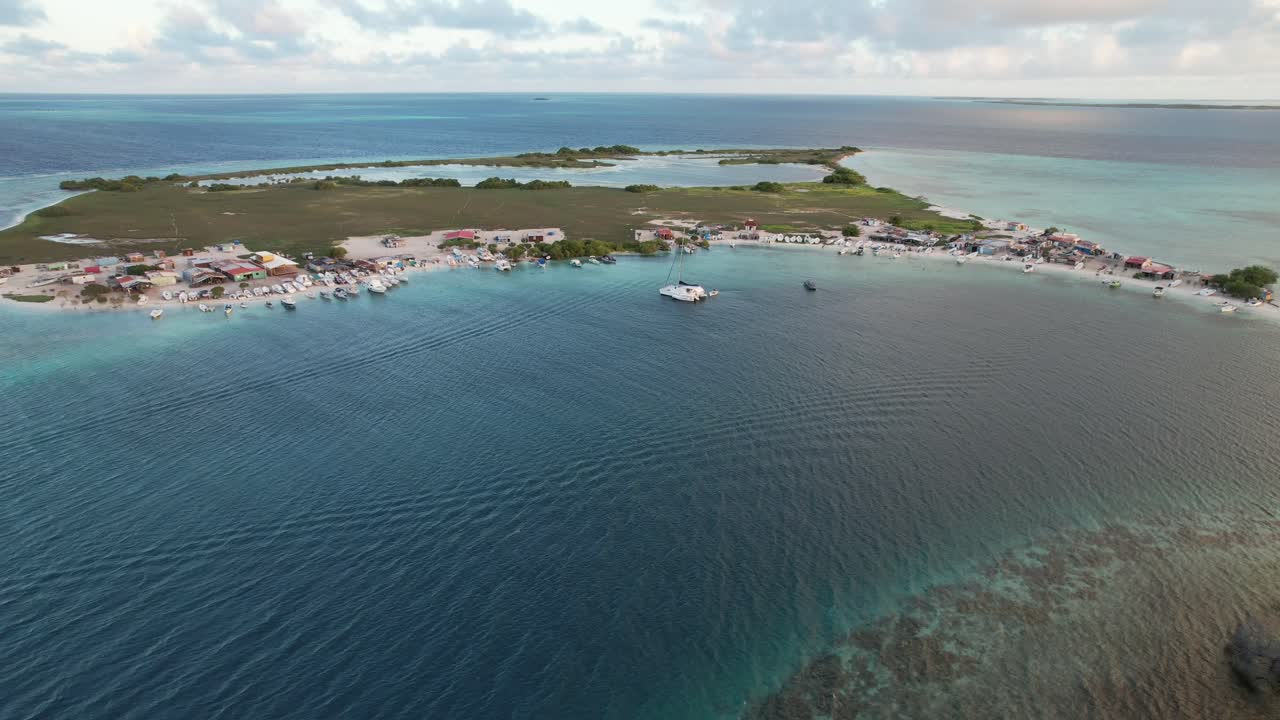 A coastal village, blue waters, boats, tranquil vibe, scenic retreat, aerial view