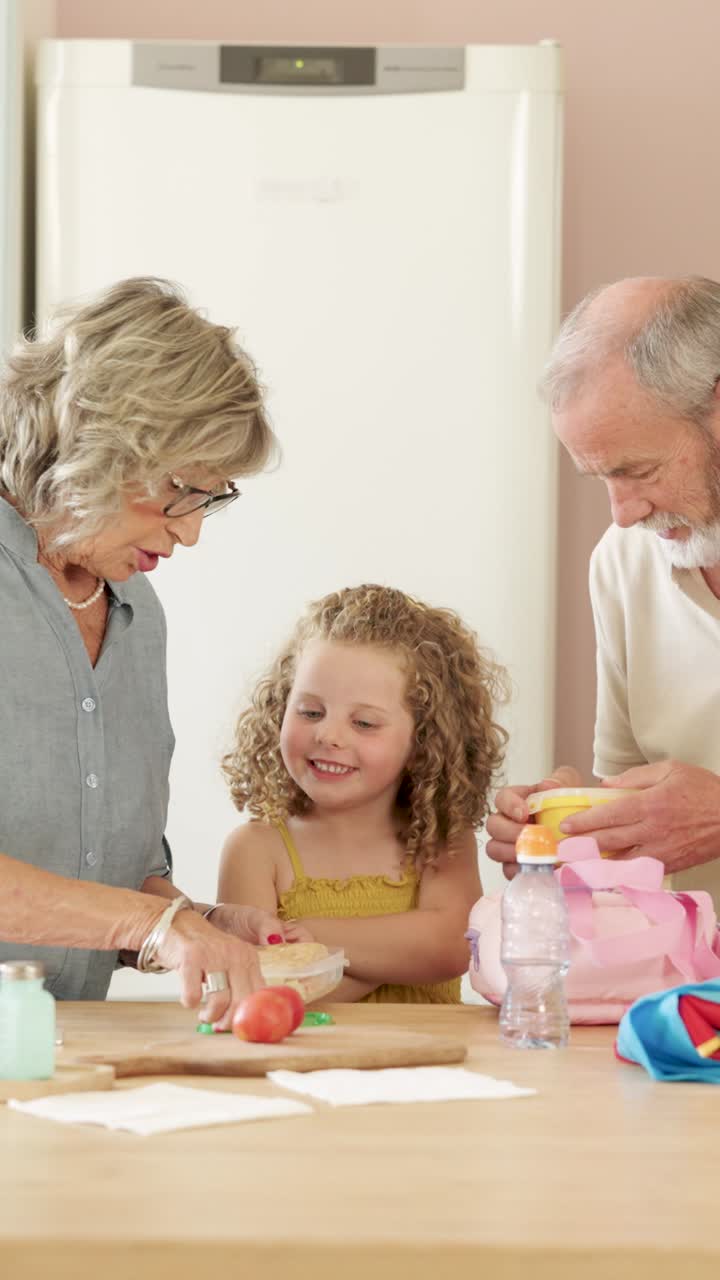 Grandparents and Child Packing Lunch Together