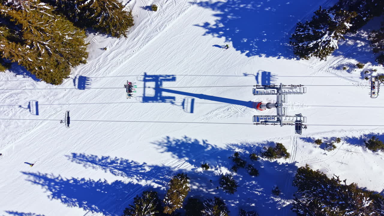 Luchtfoto van skilift en skiërs op een besneeuwde berghelling