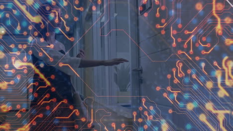 woman tapping smartphone next to building entrance door handle, displaying technology circuits