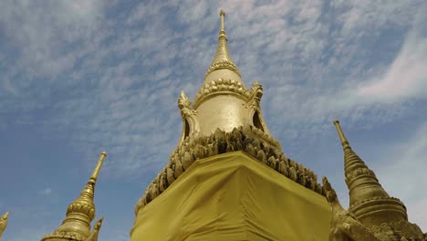 golden rooftop of a thai buddhist temple with sky view