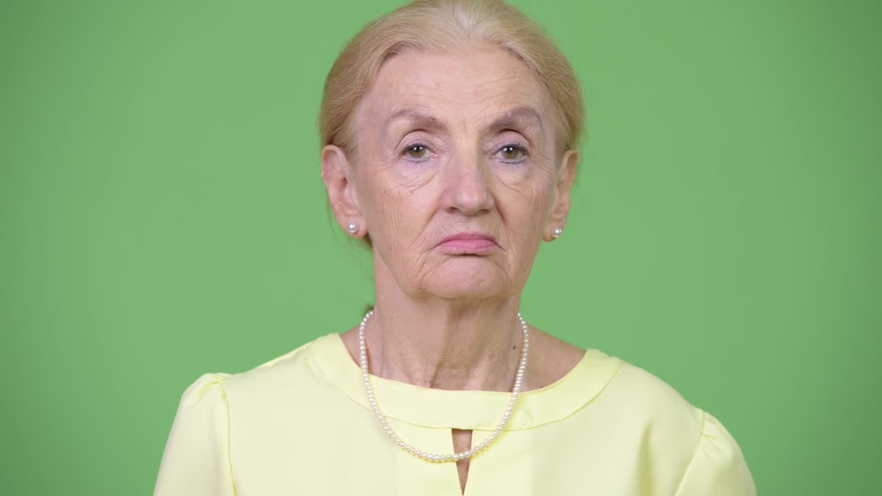 Studio shot of beautiful senior businesswoman with blond hair