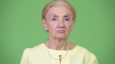 studio shot of beautiful senior businesswoman with blond hair