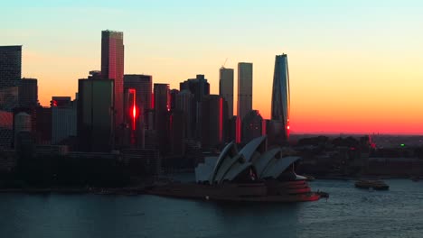 Sydney-city-Opera-House-stunning-Vivid-summer-red-orange-sunset-skyline-aerial-drone-Royal-Botanic-Gardens-Australia-view-tourist-Circular-Quay-scenic-helicopter-flight-circle-right-parallax-motion