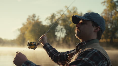 man fly fishing at sunrise