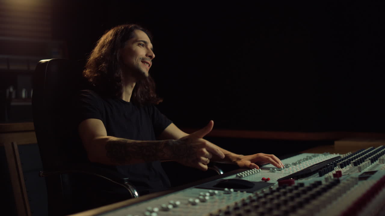 hombre alegre trabajando en un estudio de música