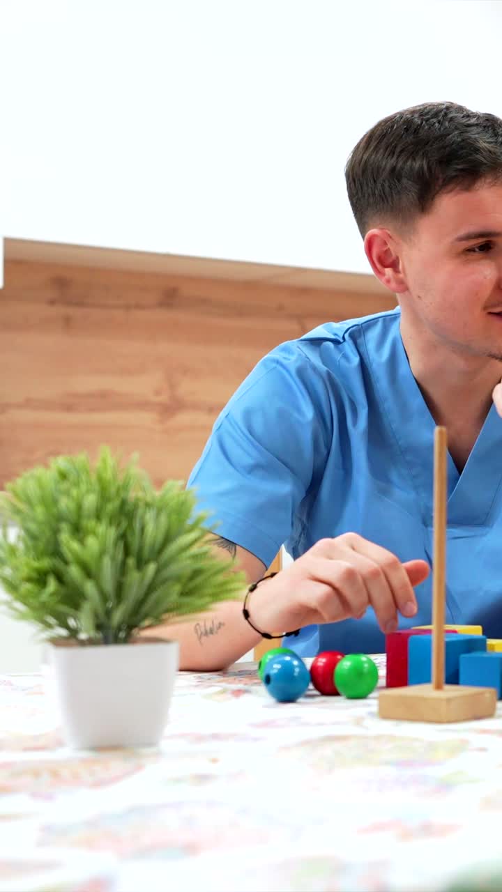 Assisted Living Activity with Caregiver and Wooden Blocks