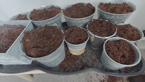 they are being watered, with water gently cascading over the buckets, nourishing the soil within