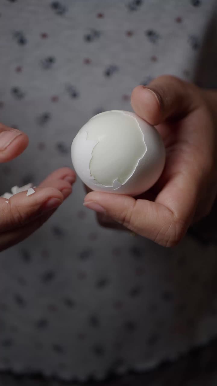 Close-up of Hands Peeling a Hard-Boiled Egg