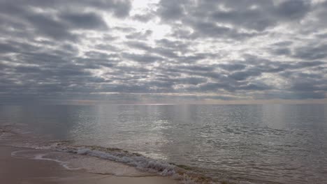 the ocean surf on a deserted sandy beach