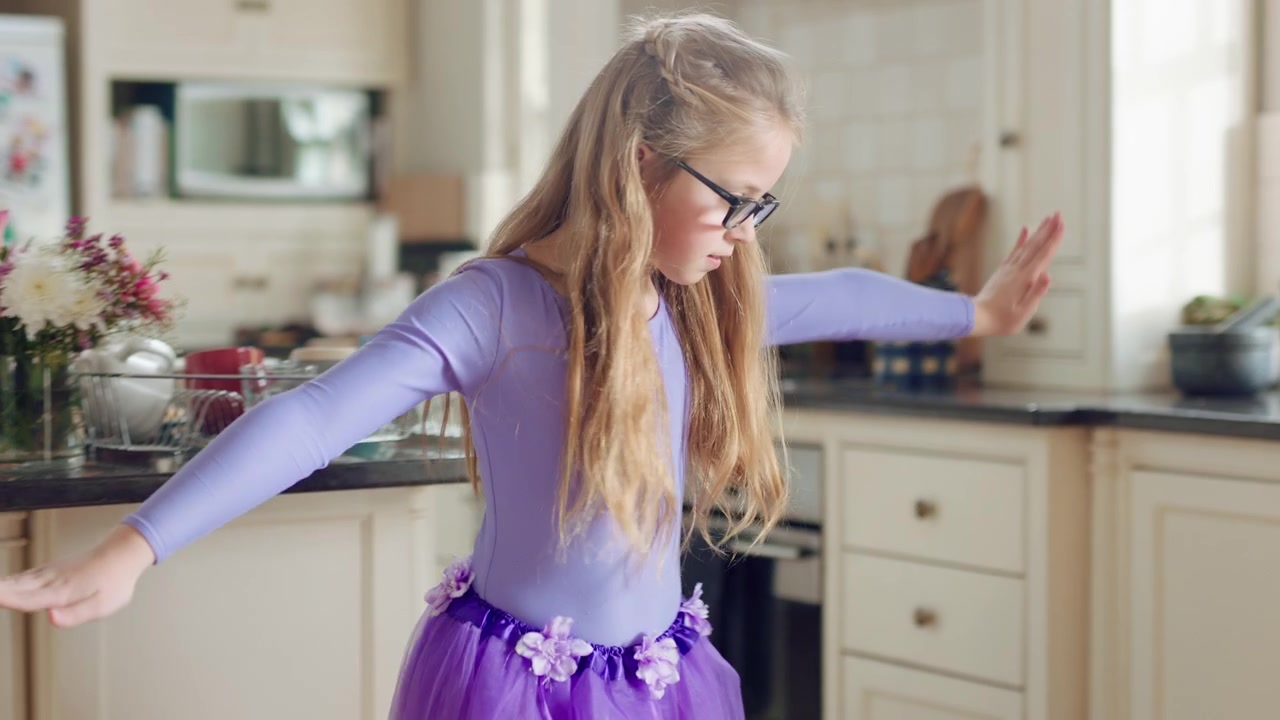 Young Girl Dancing in Purple Tutu in Kitchen