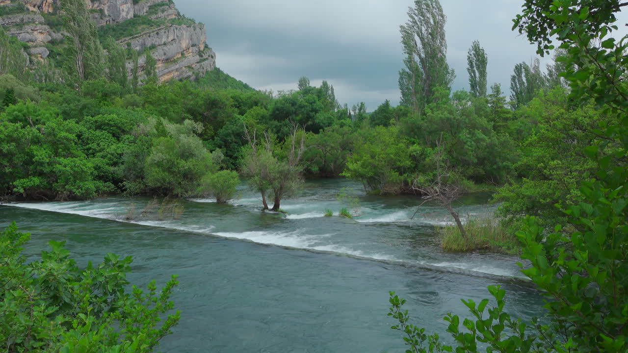 Waterfall Krka National Park with plants growing out of the water