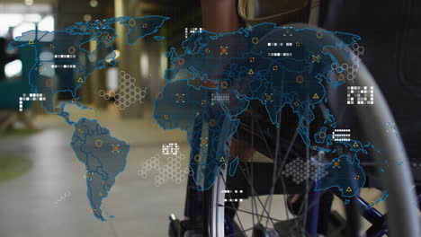 animation of world map against low section of a disabled woman on wheelchair at office