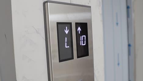 digital elevator display showing floor number - elevator going up and down in the mall, hotel or business center - closed view