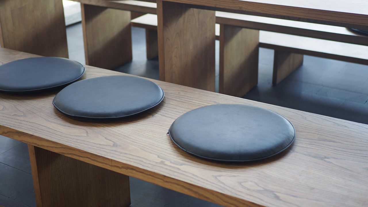Modern Wooden Bench with Round Cushions in a Cafe