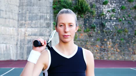 female tennis player with racquet in the court