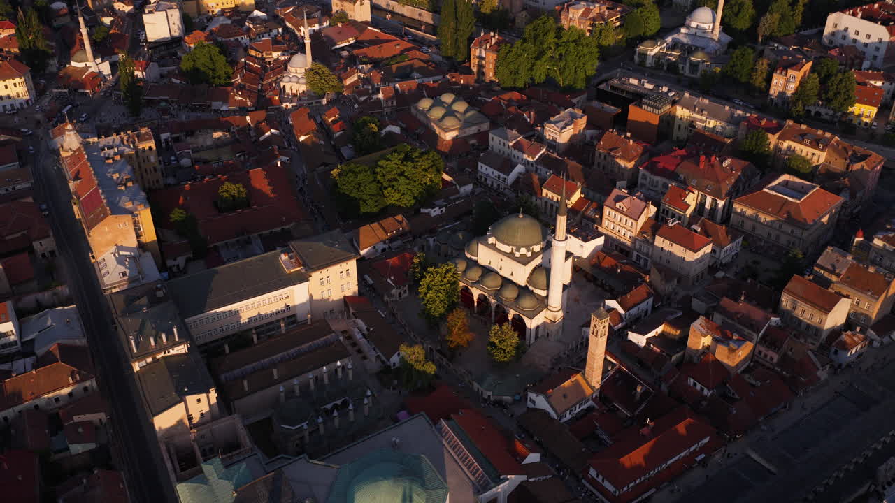 Sarajevo Clock Tower And Gazi Husrev-beg Mosque At Sunset In Sarajevo, Bosnia and Herzegovina. Aerial Drone Shot