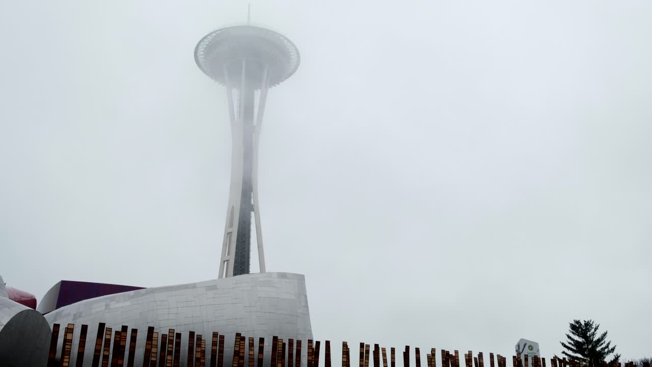 Cloudy overcast shot of the futuristic space needle skyscraper observation tower -  It is a city landmark and is considered an icon of Seattle