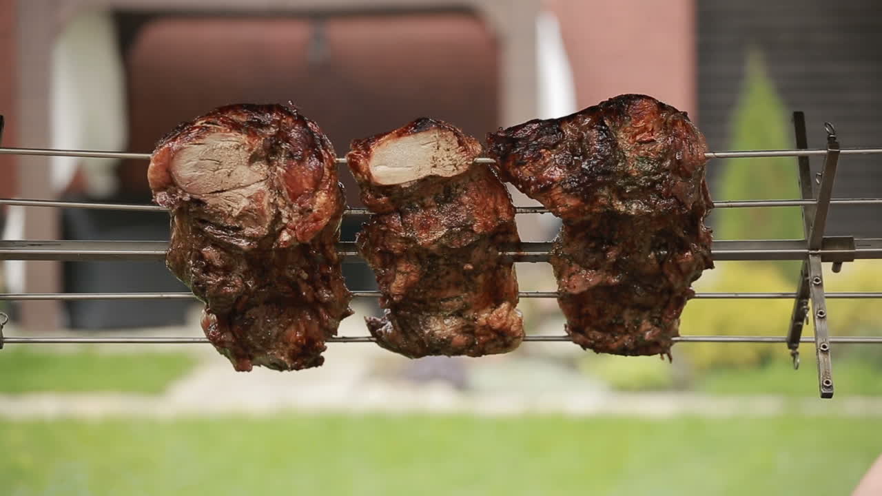 Grilling steaks with flames. Tasty beef steaks on the grill with fire flames