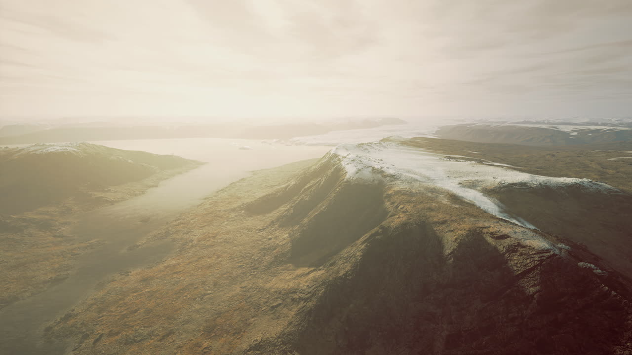 A stunning panorama showcases majestic mountain ranges along a tranquil lake